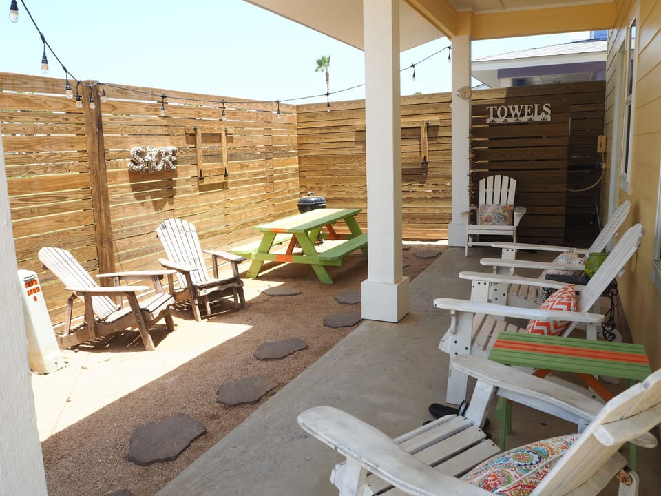 Covered Back Porch with plenty of seating and lighting for nights

