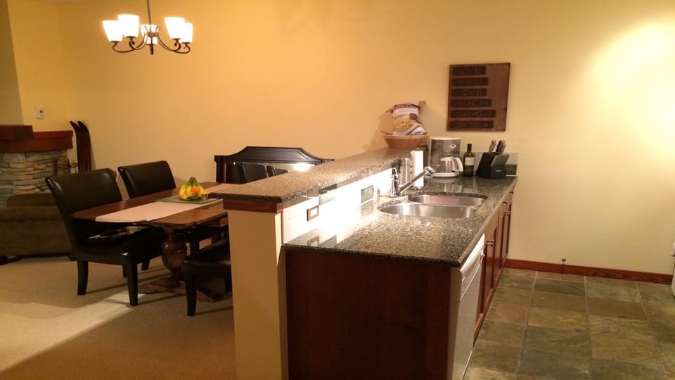 GRANITE COUNTERTOPS, KITCHEN AMENITIES ALL WITH HEATED SLATE FLOORS