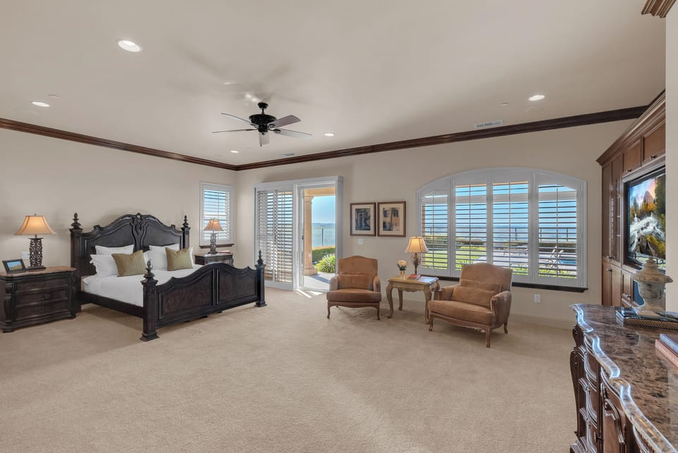 Primary Bedroom: Unwind in the spacious king suite with direct patio access and peaceful outdoor views.