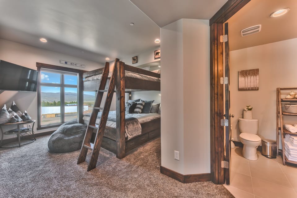 Bedroom 2 with a 55" Smart TV, Electric Blinds, PS4 Gaming System, Nintendo Switch Doc and Private Bath