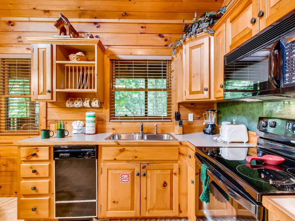 Fully-equipped kitchen is rustic and charming and spacious enough for all your food prep needs.