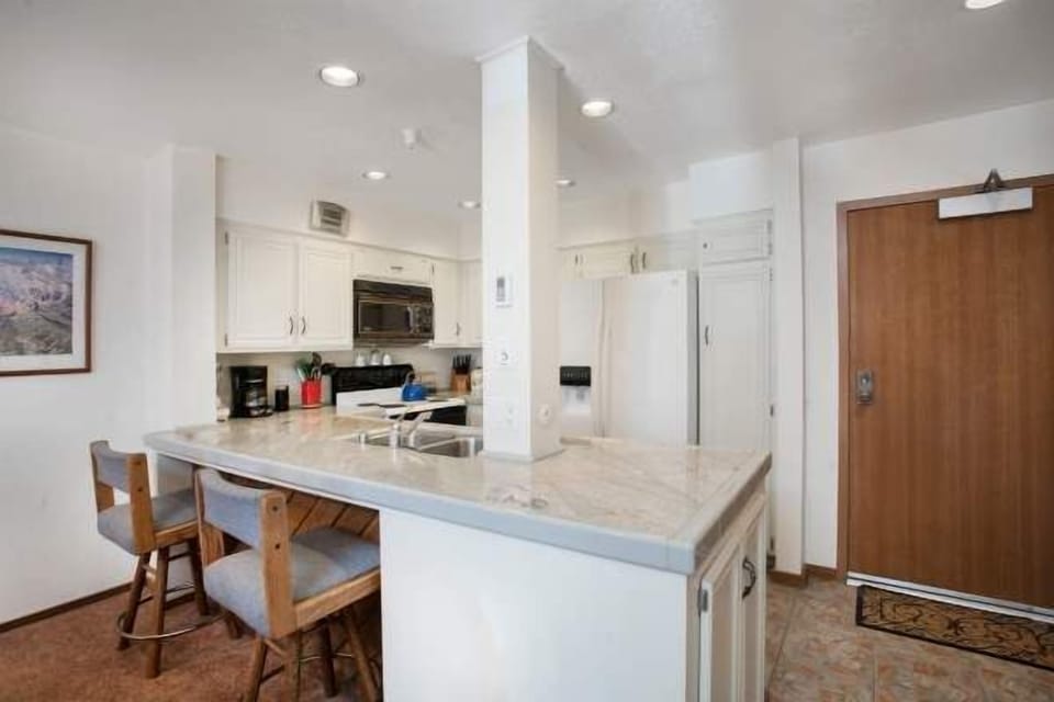 Open kitchen with upgraded fixtures.