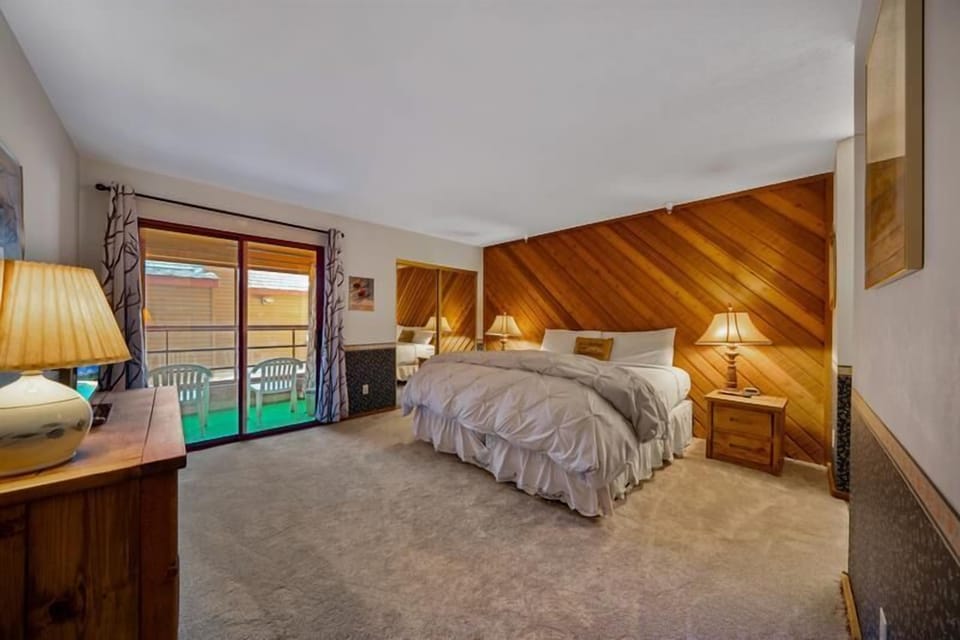 Spacious bedroom with access to porch, fresh air.
