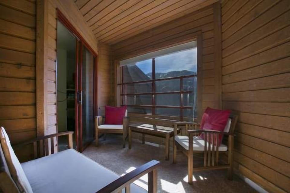 Enclosed porch with chairs to relax.