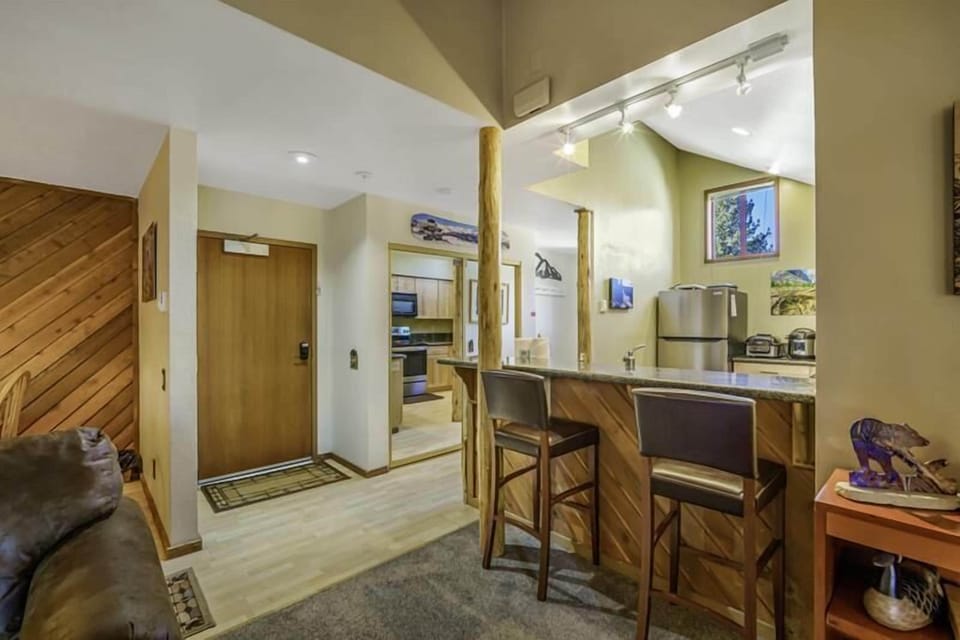 Two kitchen bar stools add seating options.