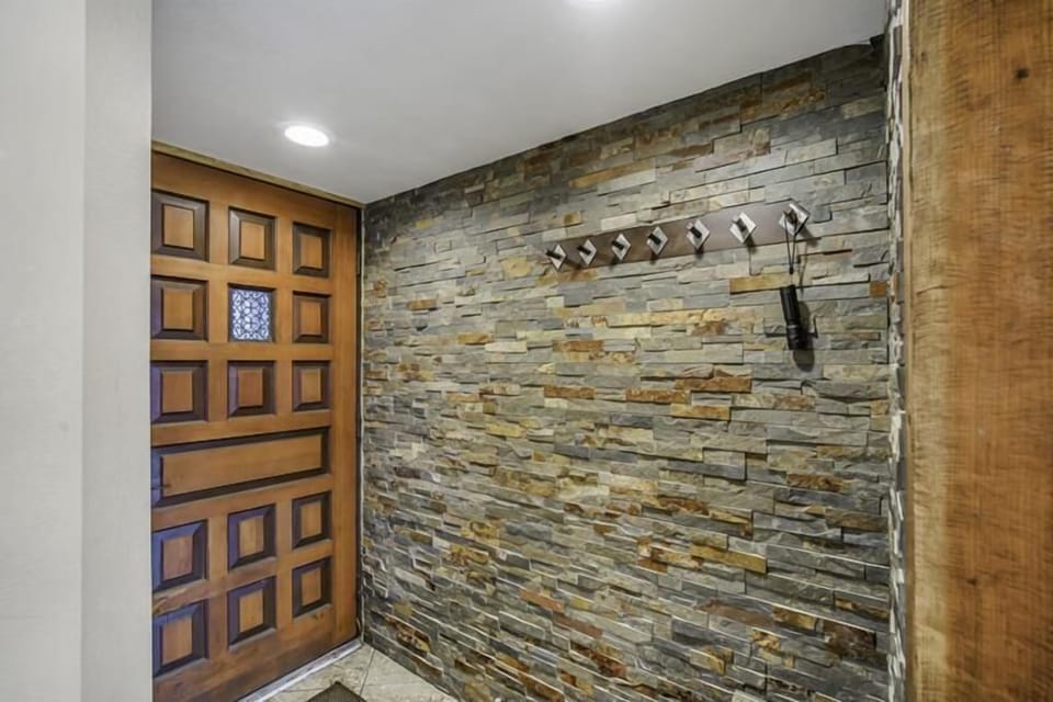 Entry with coat hooks and custom rock work
