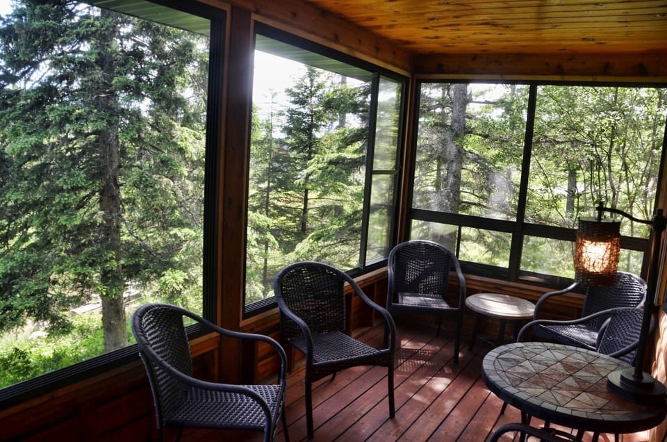 Fabulous 3 season porch! Windows open to 75% screen for air flow & wooded views.