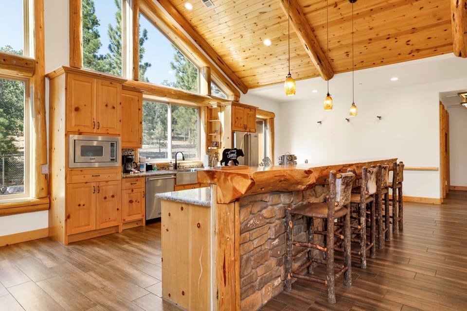 Fully equipped cabin kitchen with ample cabinetry, stove, fridge, microwave, and coffee maker—perfect for cooking meals, morning coffee, and feeling right at home on your stay.