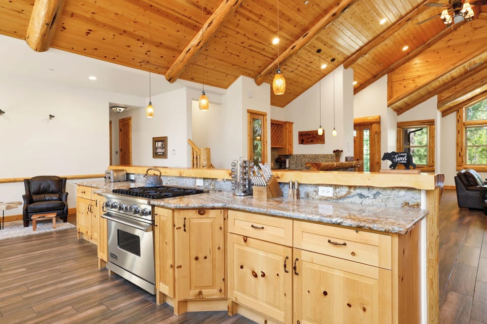Fully equipped cabin kitchen with ample cabinetry, stove, fridge, microwave, and coffee maker—perfect for cooking meals, morning coffee, and feeling right at home on your stay.