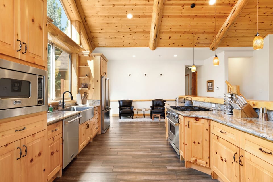 Fully equipped cabin kitchen with ample cabinetry, stove, fridge, microwave, and coffee maker—perfect for cooking meals, morning coffee, and feeling right at home on your stay.