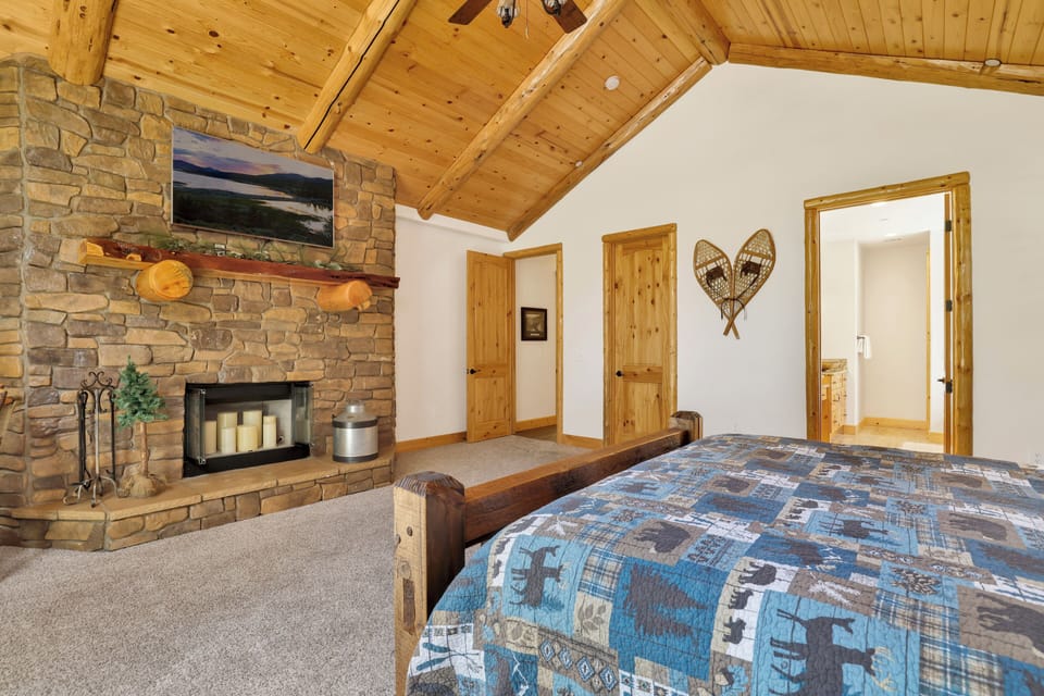 Peaceful cabin bedroom with plush bedding, and beautiful views—ideal for restful nights, cozy mornings, and a relaxing mountain escape.