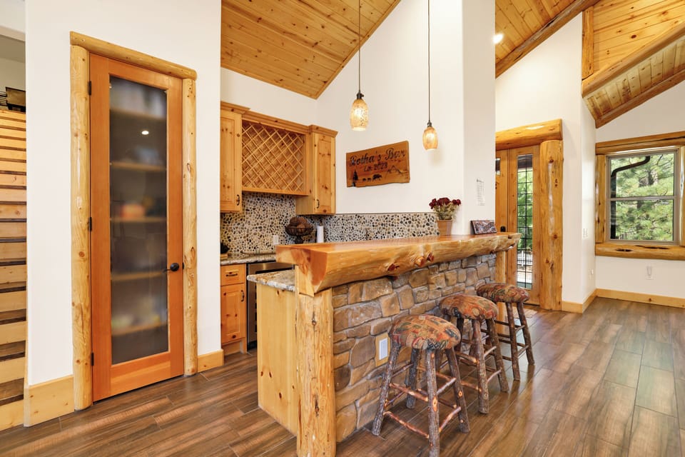 Fully equipped cabin kitchen with ample cabinetry, stove, fridge, microwave, and coffee maker—perfect for cooking meals, morning coffee, and feeling right at home on your stay.