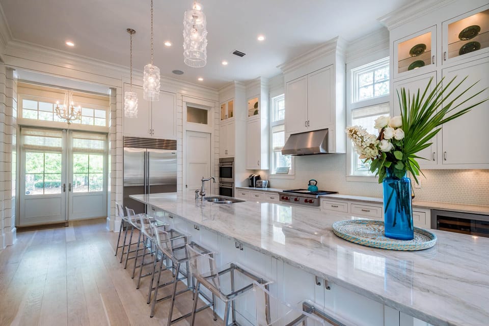 Juliska lanterns float over quartzite counter top which seats 6.  