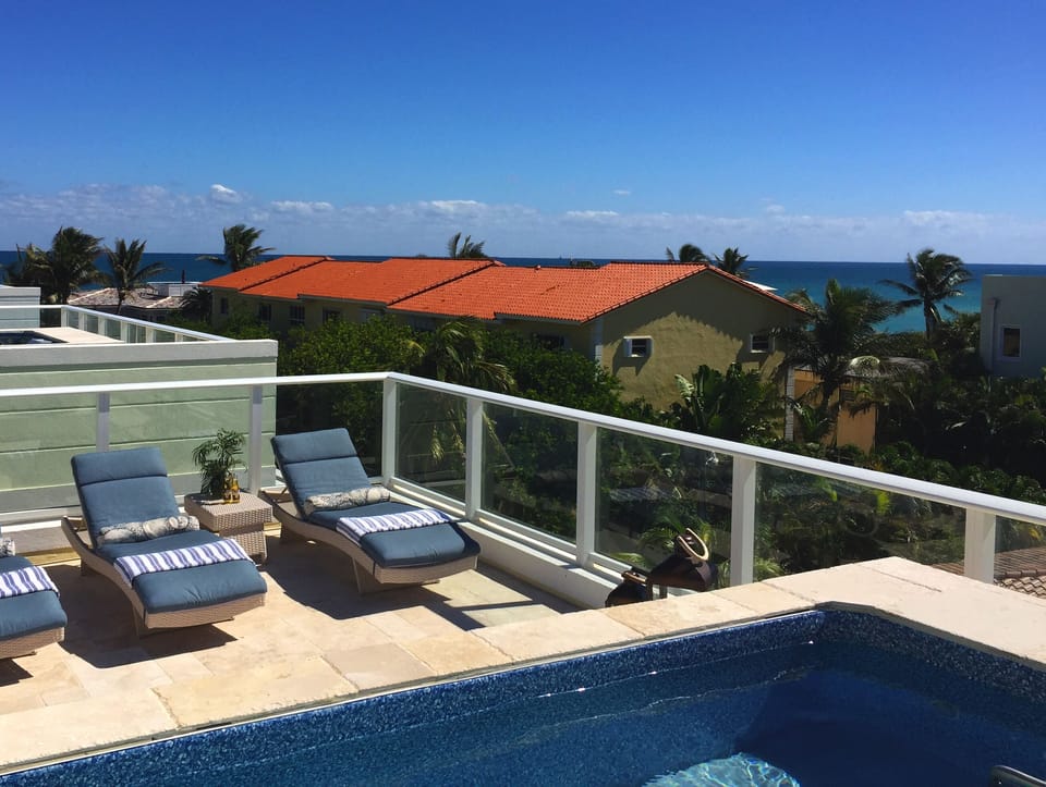 Ocean breezes and palm trees from your rooftop oasis with Endless swimming pool!