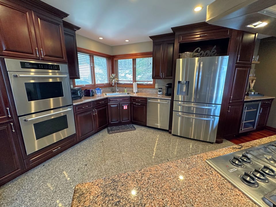 Well-appointed kitchen offers high-end appliances, double ovens, and a drip coffee maker