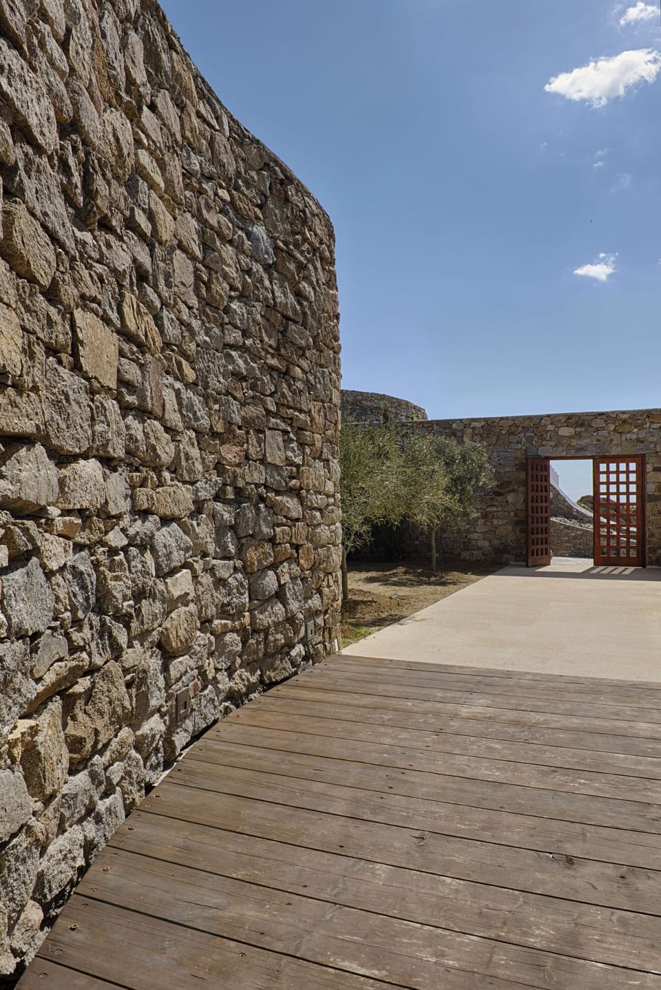 Olive tree garden, bioclimatic architecture including hand-made thick walls