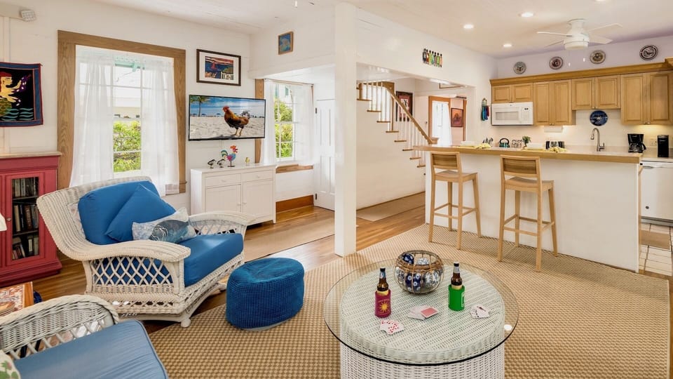 The living room furniture surrounds the large flat screen TV...