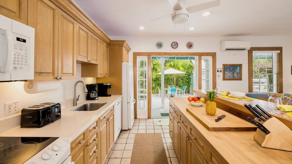 The open floor plan keeps everyone connected, with the pool area just steps from the kitchen and living room...