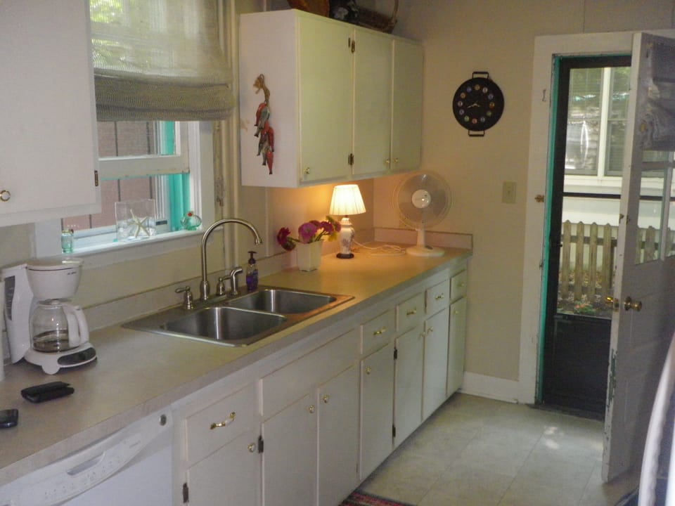Kitchen, showing door to the backyard; outside shower down the steps to the left