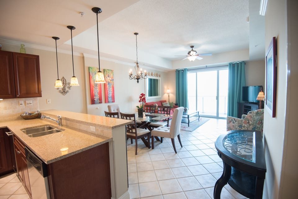 An airy, open floor plan connects the kitchen, dining room, and living room.