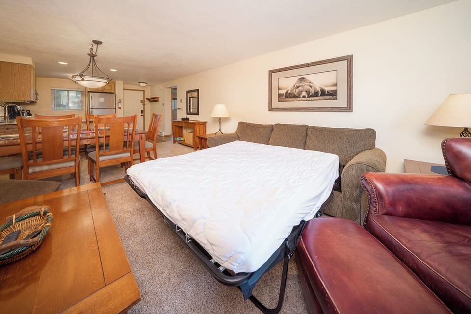 Unwind on your cozy sofa bed while enjoying the open-concept living space with full kitchen and dining area.