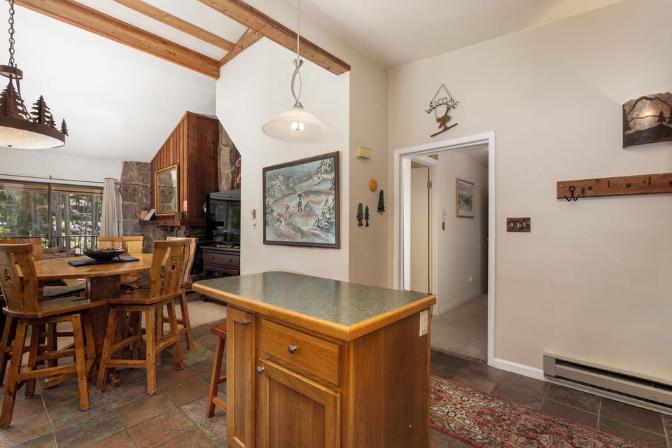 Step into your cozy mountain retreat with rustic wood beams, charming exposed stone, and warm lighting that creates the perfect après-ski atmosphere.