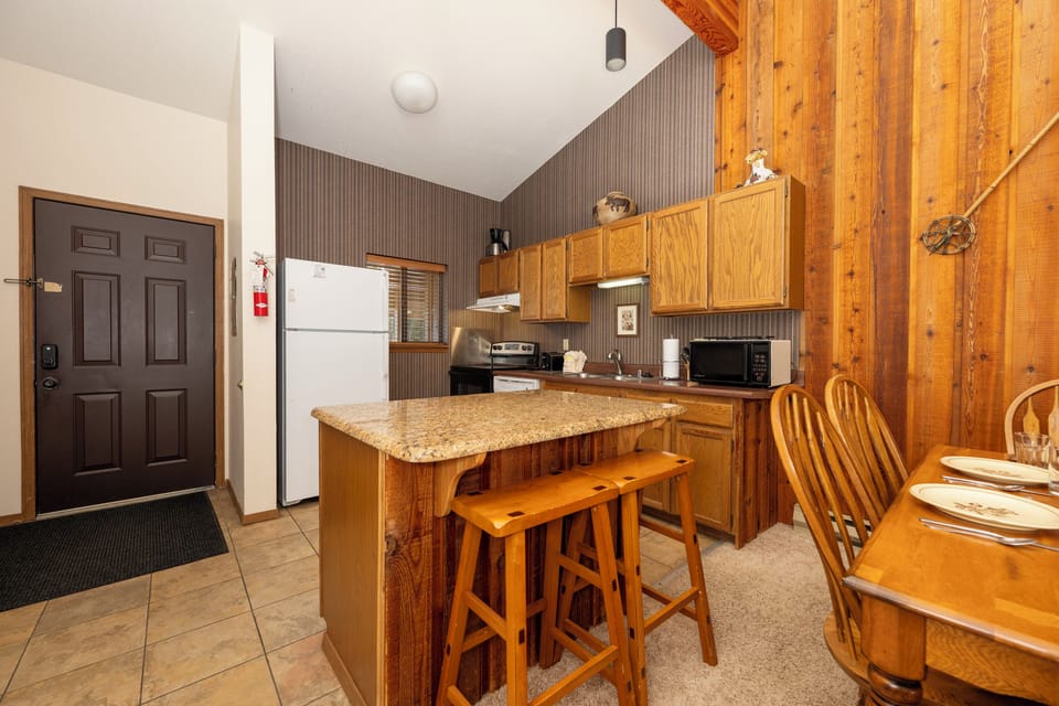Your fully equipped kitchen features warm wood cabinets, granite counters, and everything you need to prepare meals during your mountain getaway.