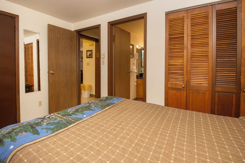 Your cozy bedroom features rich wood details and built-in wardrobes for organized storage during your stay.