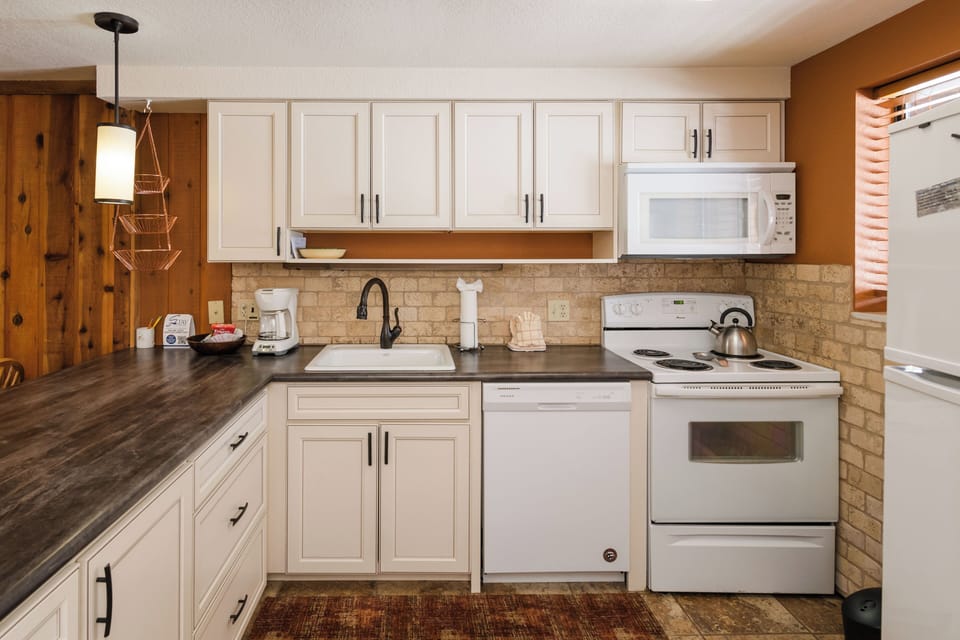 Your fully equipped kitchen features modern appliances and stone countertops, perfect for preparing meals during your stay.