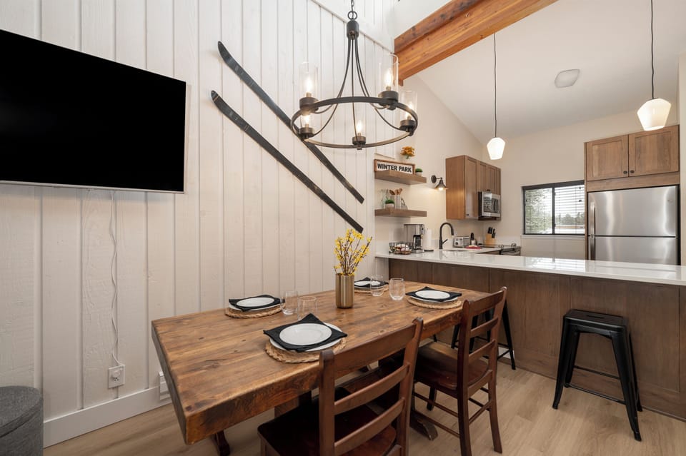 Your modern kitchen flows seamlessly into a cozy dining space where warm wood tones and stylish lighting create the perfect atmosphere for memorable meals.