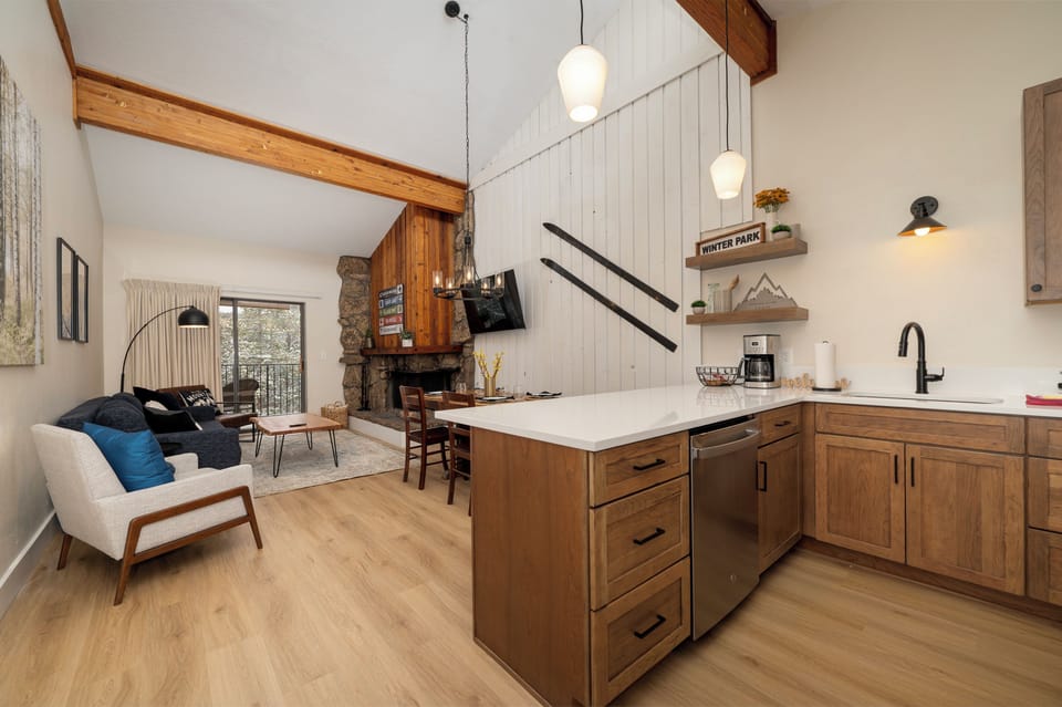 Your open-concept retreat blends warm wood tones with mountain modern style, creating the perfect space to cook, dine, and unwind together.