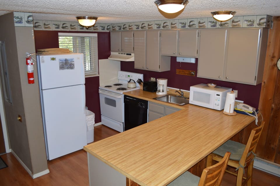 Your fully equipped kitchen features everything you need, from the spacious breakfast bar to modern appliances and coffee maker for perfect mornings.