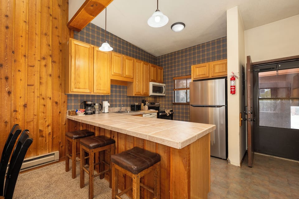 Your fully equipped kitchen features warm wood cabinets, granite counters, and stainless steel appliances—perfect for preparing meals together.
