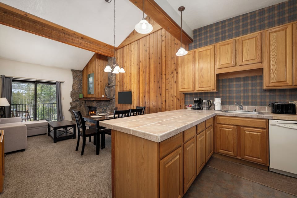 Step into your cozy mountain retreat with a fully-equipped kitchen, warm fireplace, and scenic views awaiting your arrival.