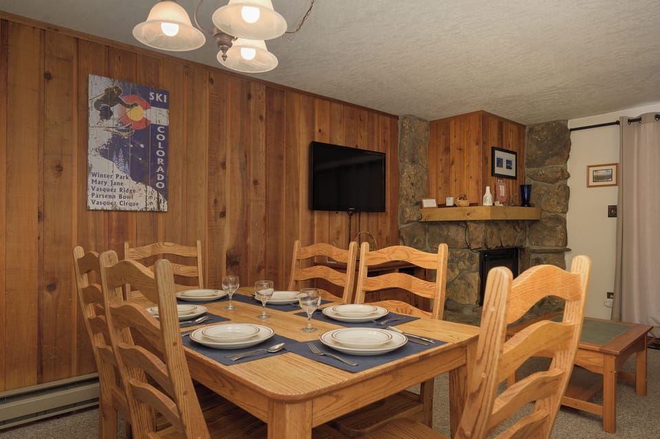 Gather around this rustic wooden dining table for memorable meals with mountain charm and fireplace warmth.