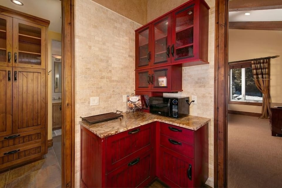 Small refreshment bar outside of the theater room with mini fridge and microwave oven.