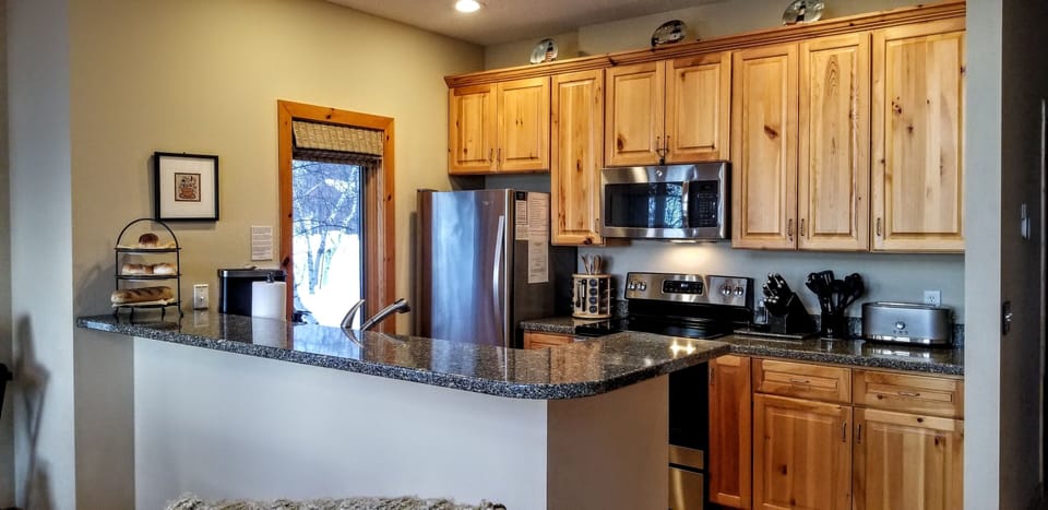 Well equipped kitchen with newer stainless steel appliances, save $ and dine in!