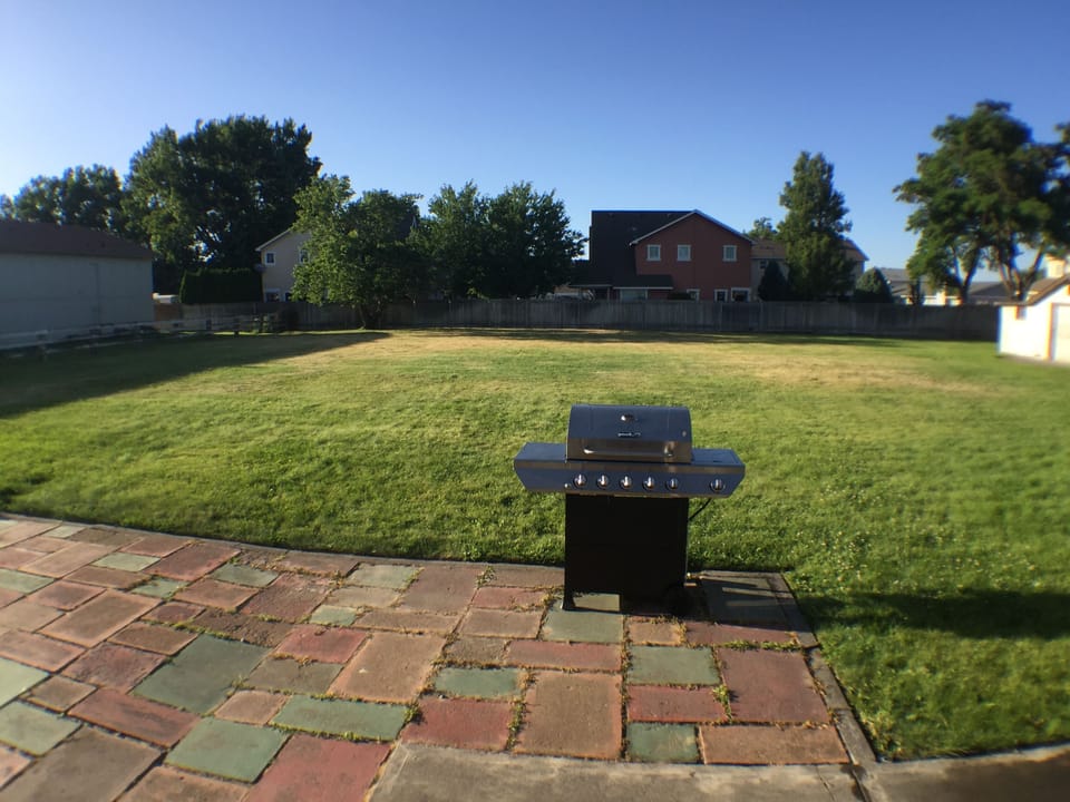 Over 1/2 acre yard with patio, seating and grill