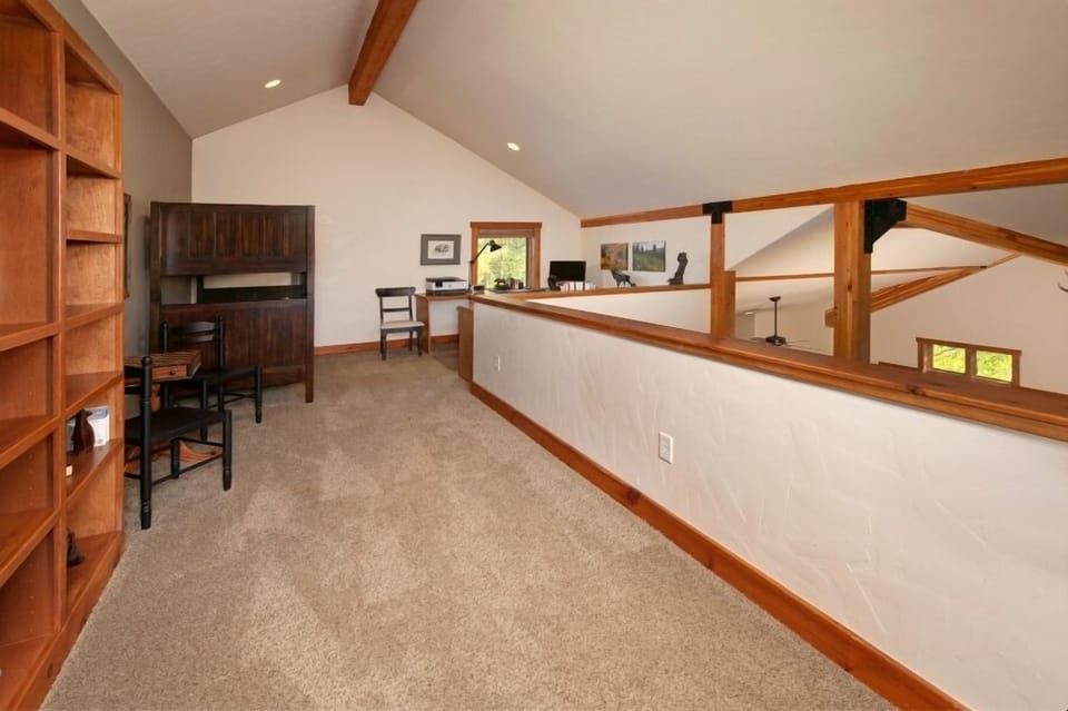 Top level loft with office area and a twin-over-twin bunk bed.