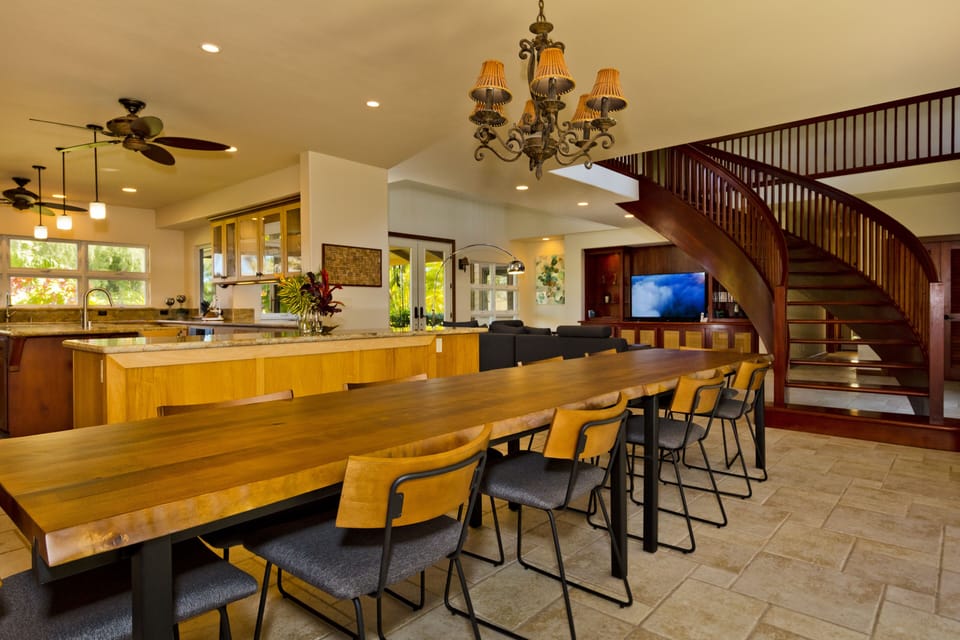 Dinning area with mahogany floating stair in the back