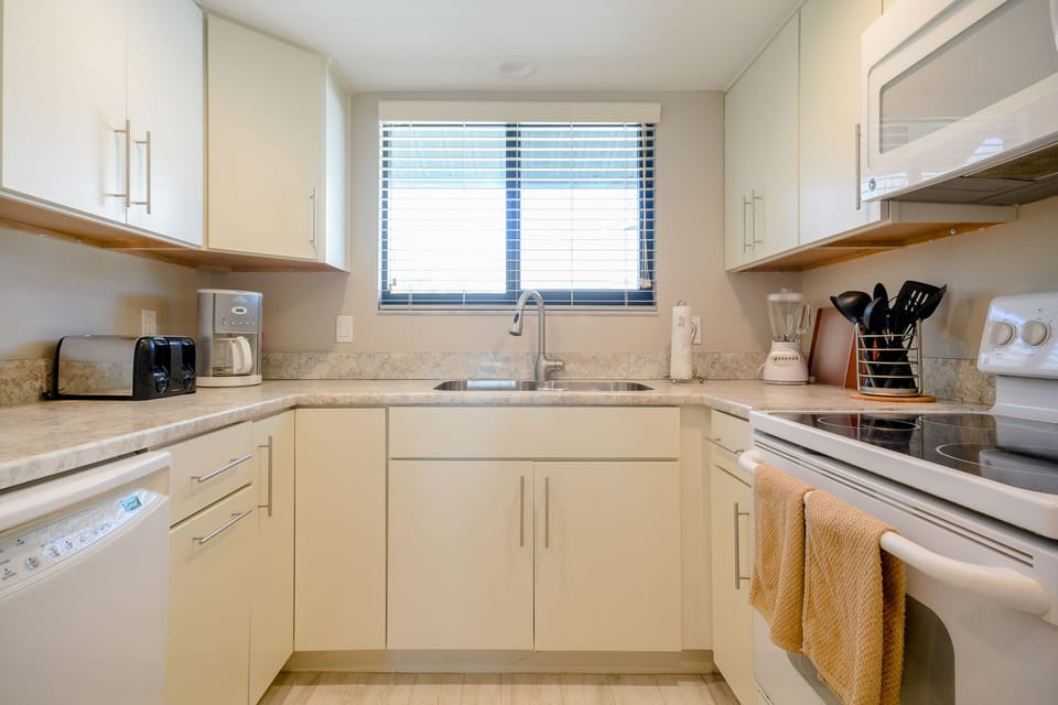 Fully equipped kitchen located in this 3 bedroom condo New Smyrna Beach