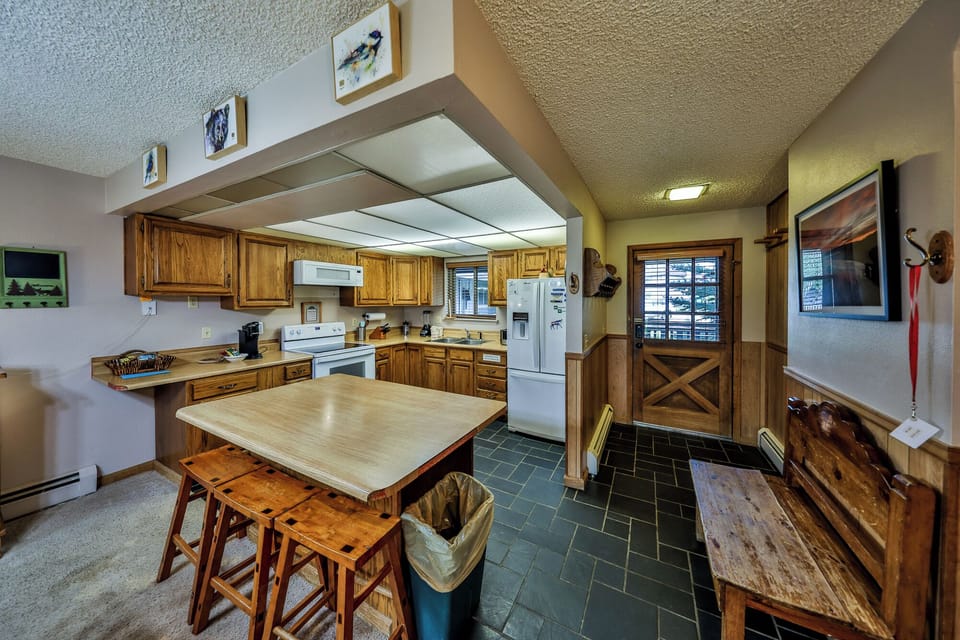 Gather around your spacious kitchen with warm wood cabinets, full appliances, and a cozy dining table perfect for family meals.