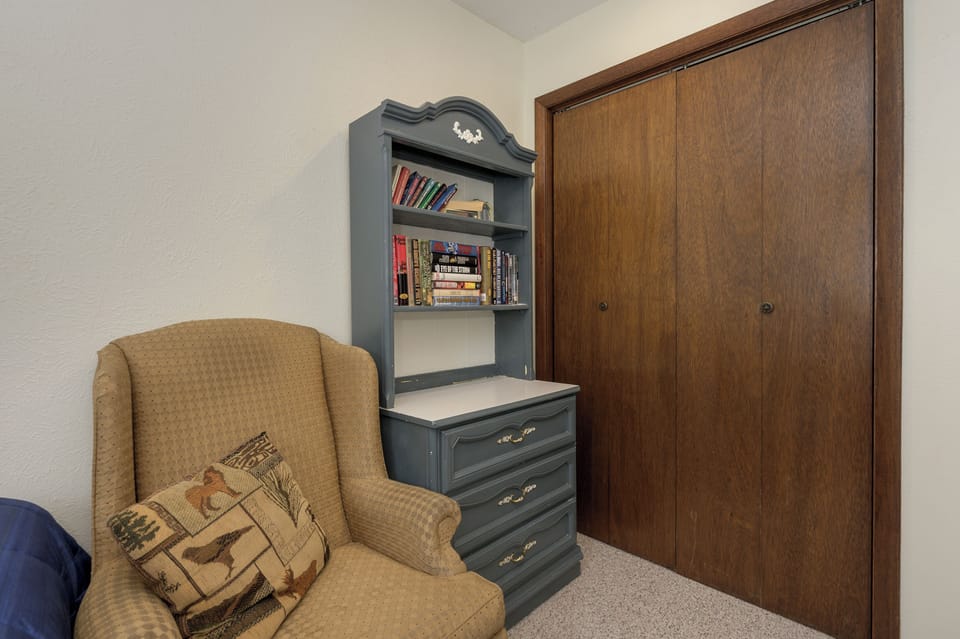 Curl up with a good book in your cozy reading nook, complete with comfortable seating and thoughtful storage.