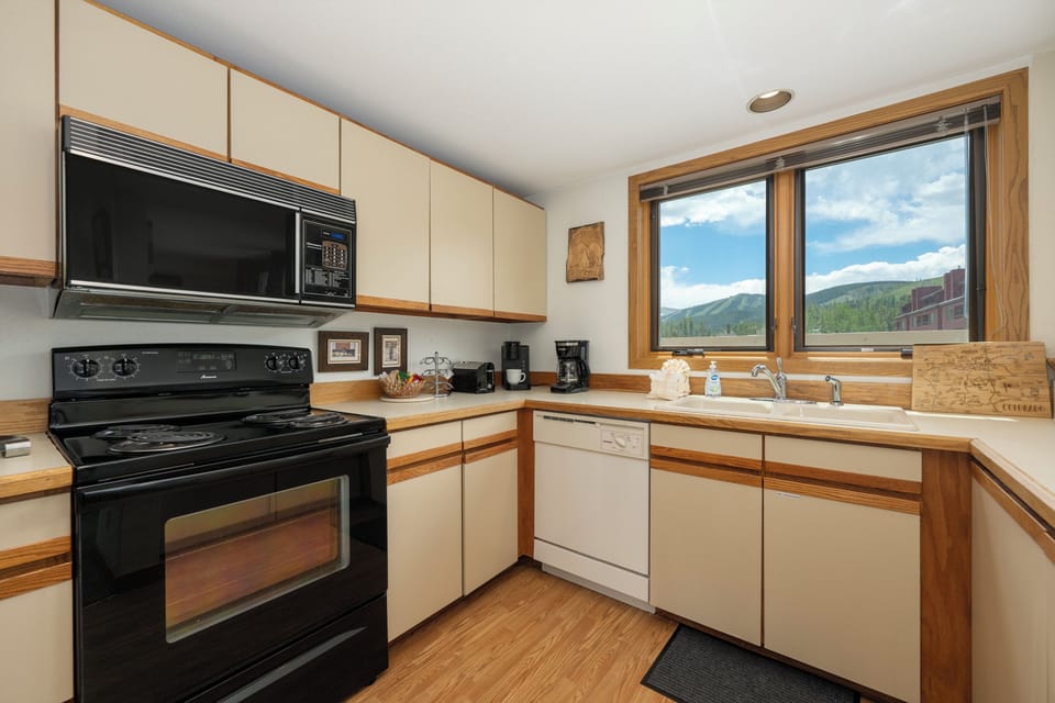 Your fully equipped kitchen features modern appliances and stunning mountain views while you cook your favorite meals.