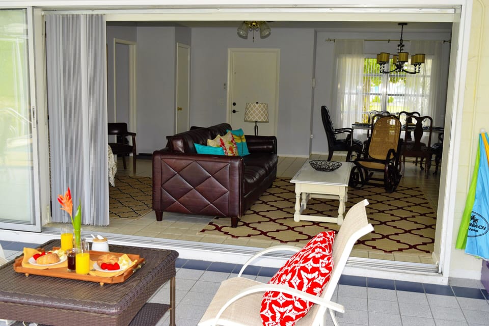 Indoor outdoor living with living room sliding doors fully open in the lanai
