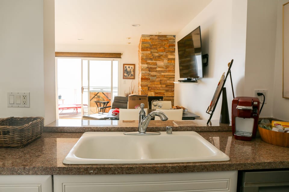 Kitchen  facing Ocean and Fireplace /55 inch TV