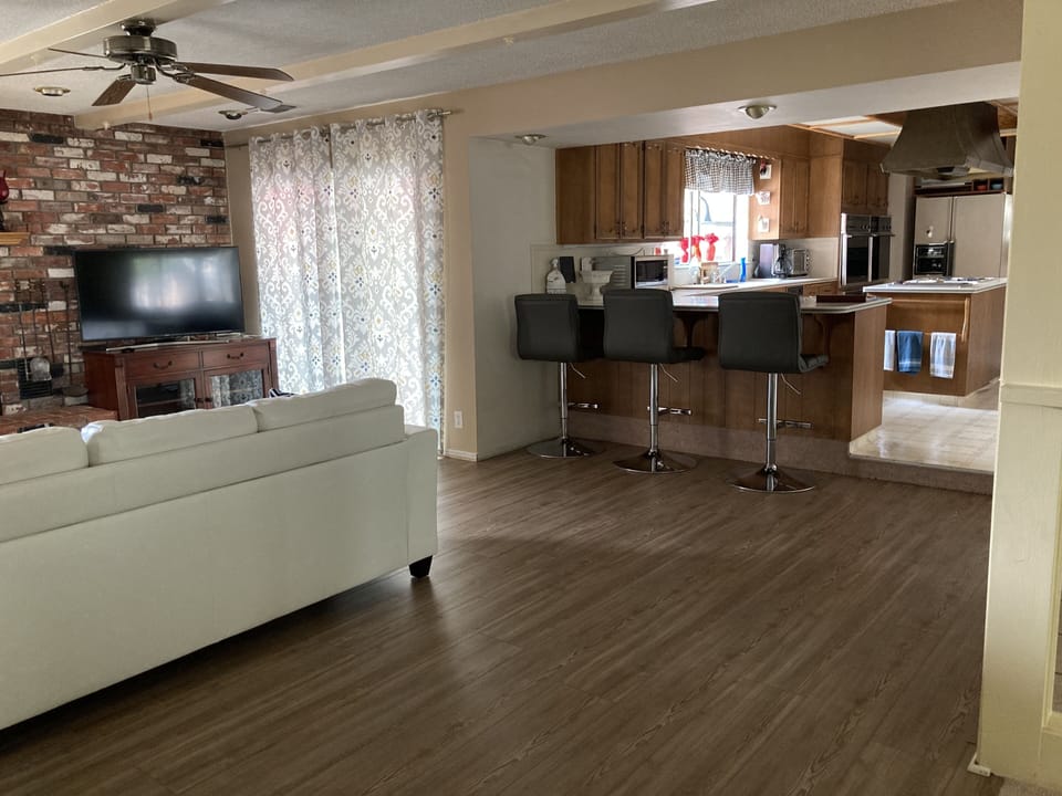 View of living room, kitchen area, slider out to the patio.
