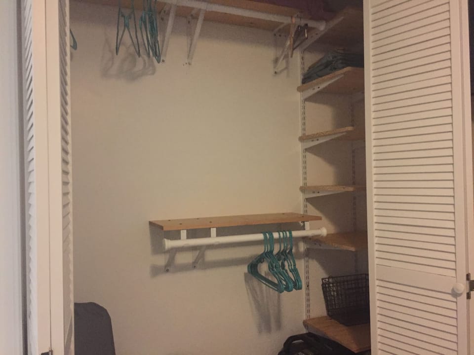Large closet in master bedroom with plenty of storage and iron/ironing board too