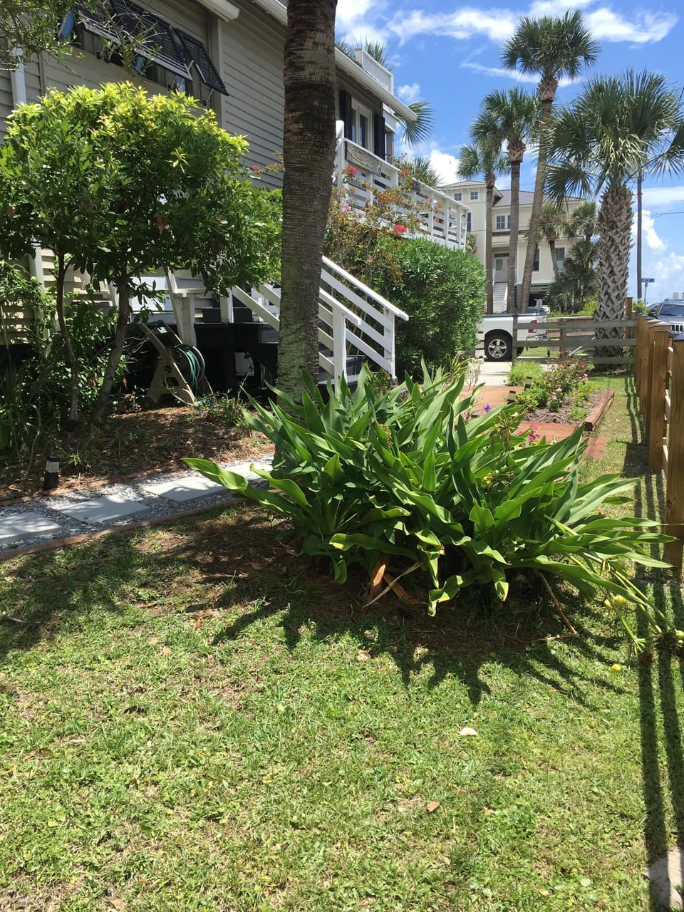 Side yard, front door entrance. Road leads to the beach access.
