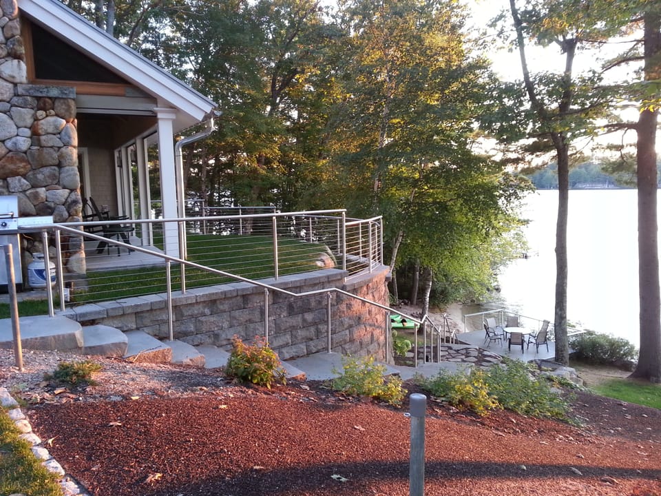 Granite stairway to waters-edge deck and beach beyond